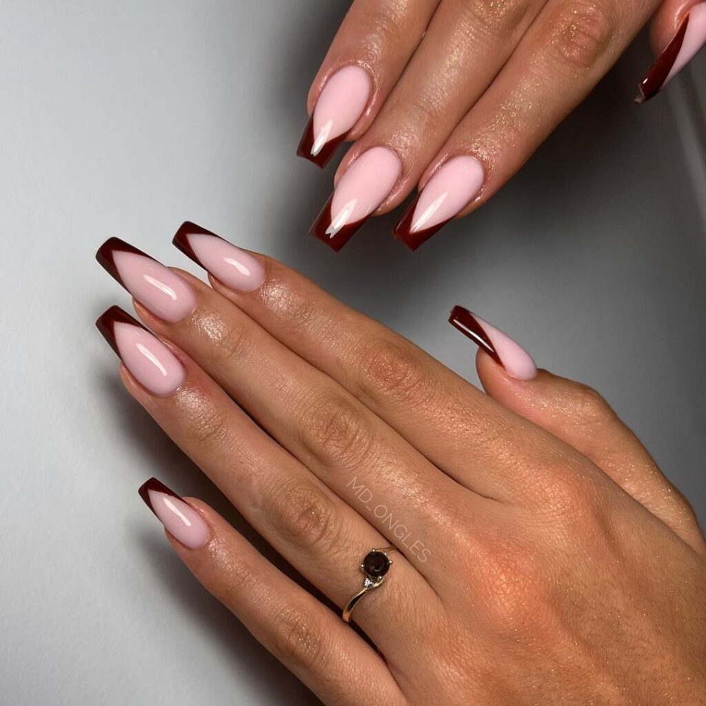 Seasonal French tips design with deep chocolate brown edges on a soft nude base, offering a sophisticated and modern fall look.