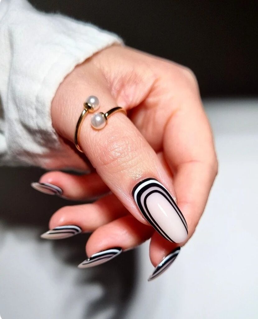 Minimalist black-and-white fall nail design featuring subtle curves and contrasting lines for a sleek, modern look.