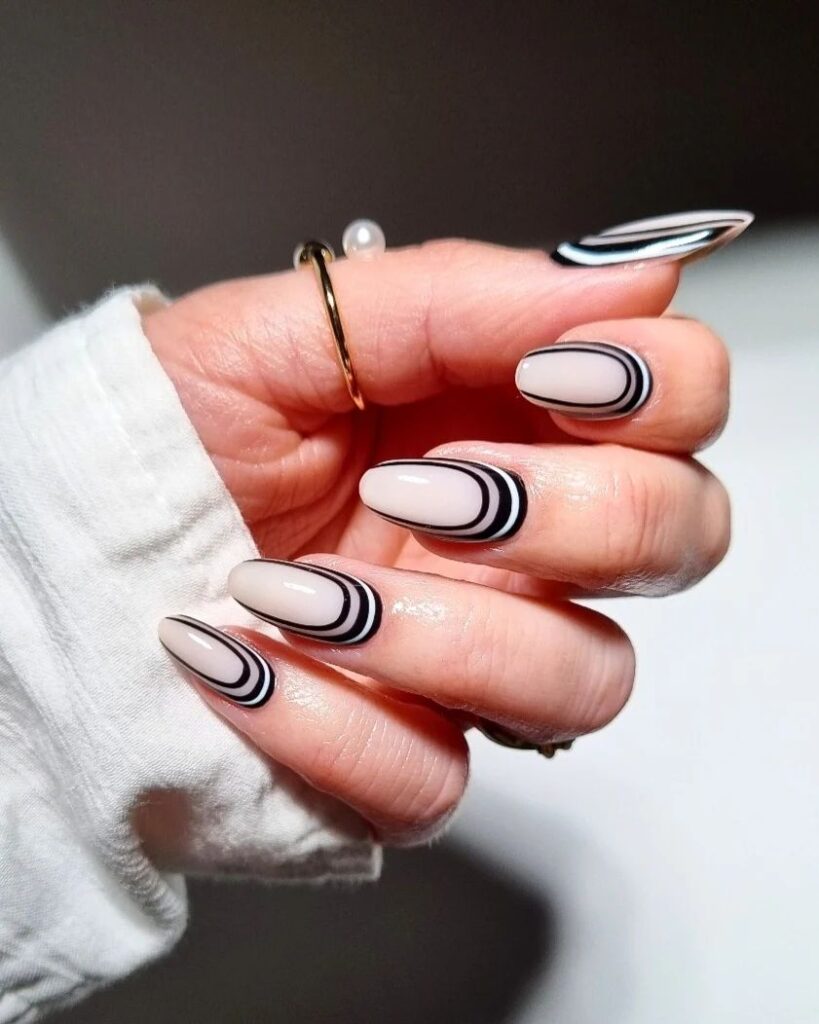 Minimalist black-and-white  nail design featuring subtle curves and contrasting lines for a sleek, modern look.