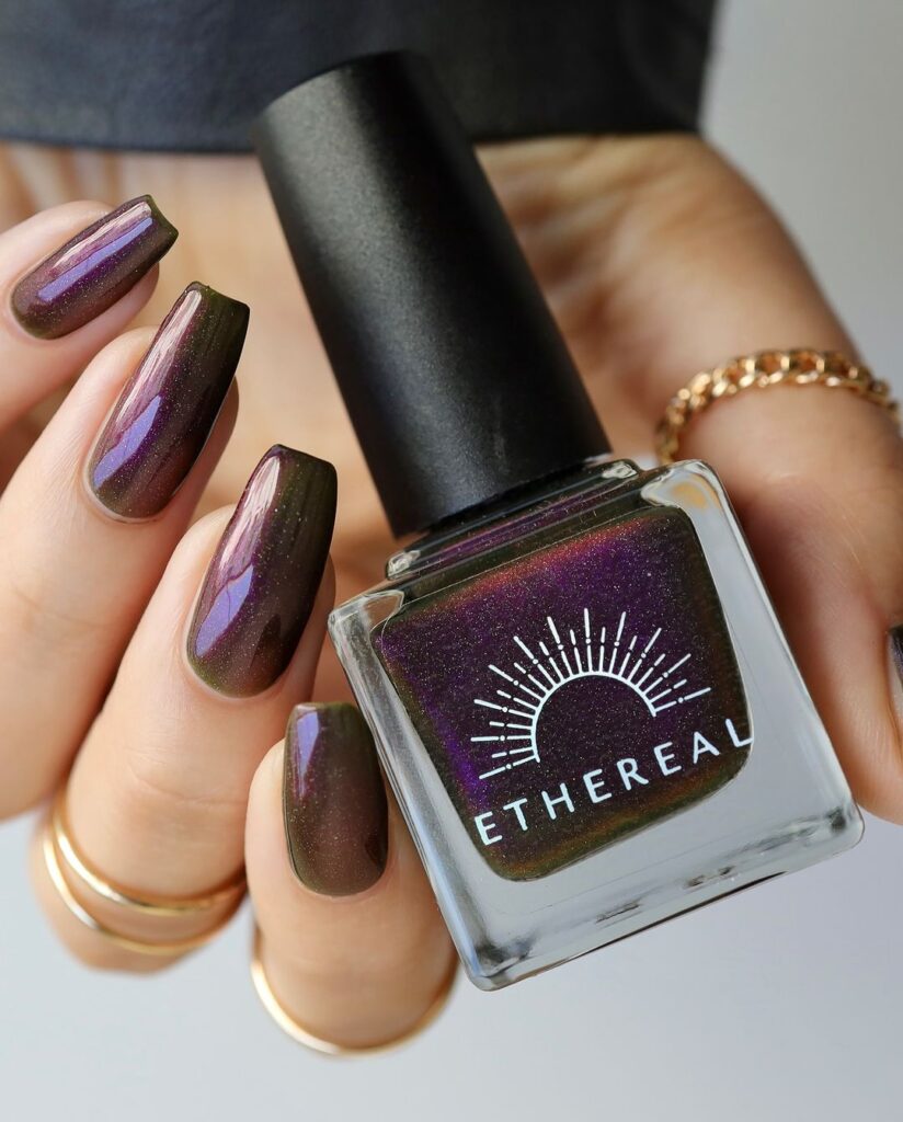 Fall nail design with a dark green base and rich burgundy shimmer, capturing a mysterious and enchanting autumn vibe