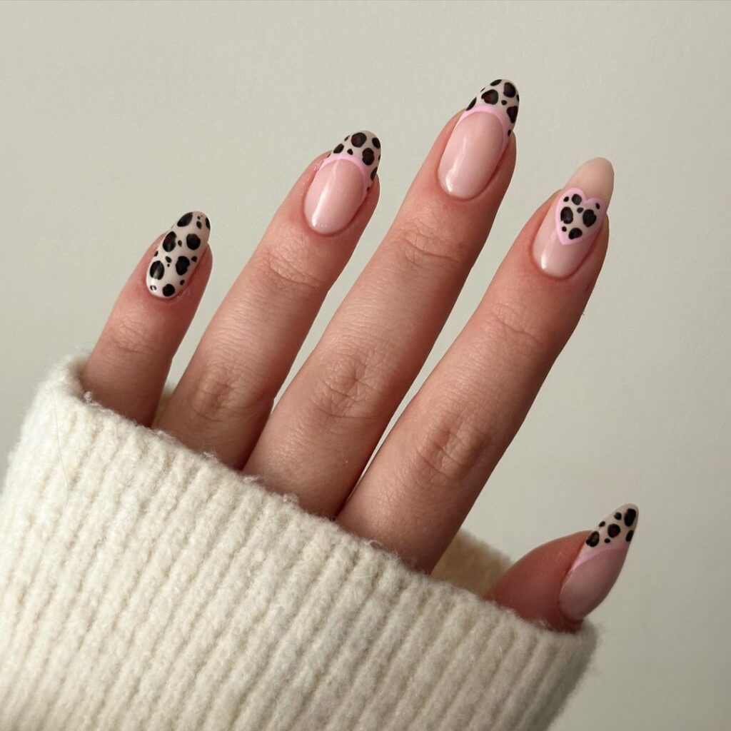 nail design featuring leopard print with soft pink accents, combining neutral tones with animal print for a fun and chic look.